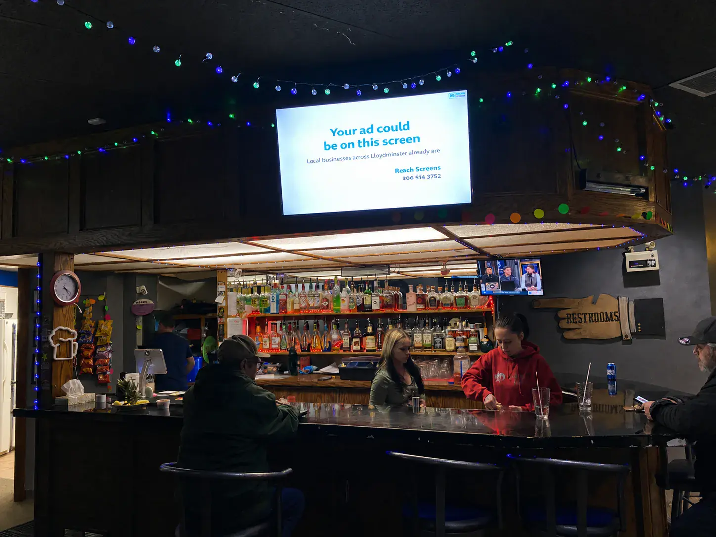 Bar and Lounge — patrons at the bar under the screen