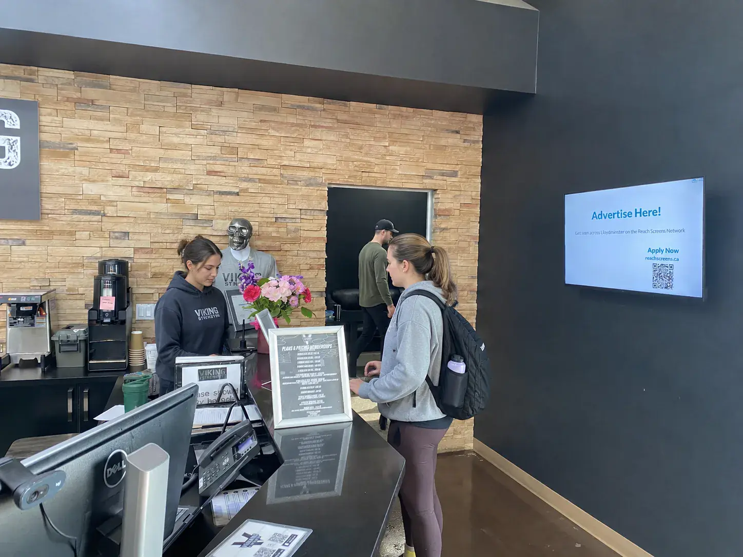 Gym — counter staff serving a member